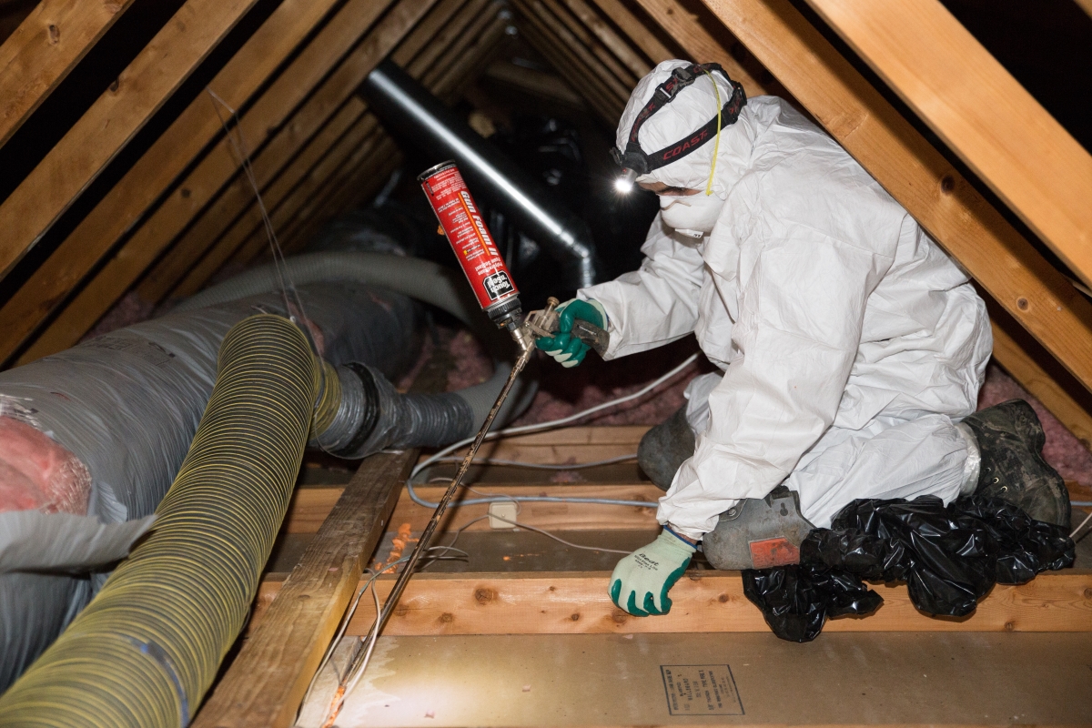 Crawl Pros professional spraying protective film in attic