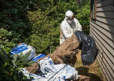 Crawl Pros professional cleaning up old material and beris during a crawl space clean out