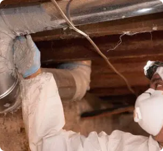 Crawl Pros professional looking at the sealant on a duct during a duct sealing