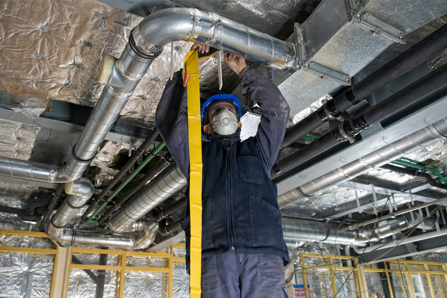 Crawl Pros professional performing a crawl space duct cleaning