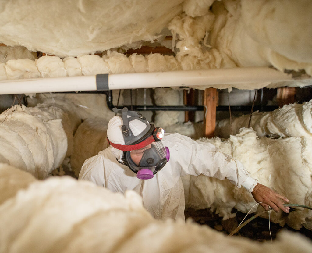 Crawl Pros professional in a crawl space completing an insulation install