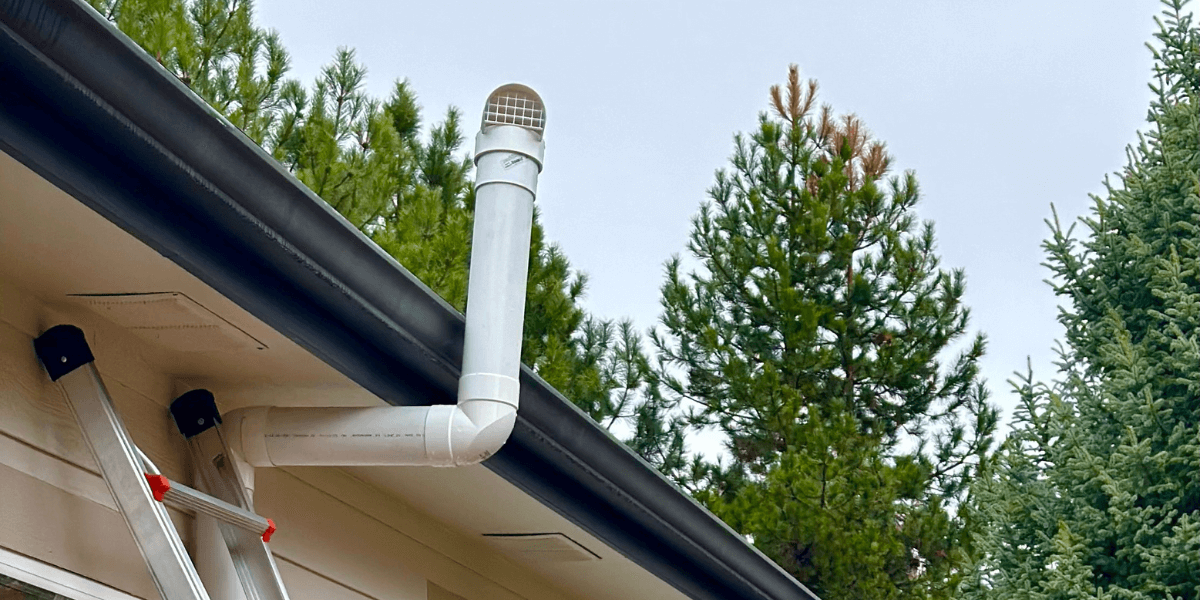 A radon mitigation pipe on the outside of a home